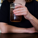 A woman holding a glass of Torched Earth, New Belgium's climate change-inspired beer.